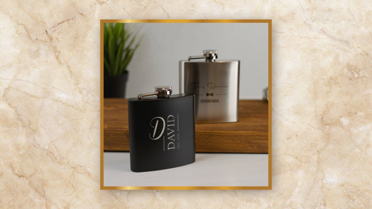 A black colored hip flask with David written on it kept on a table as personalized wedding gifts. 

