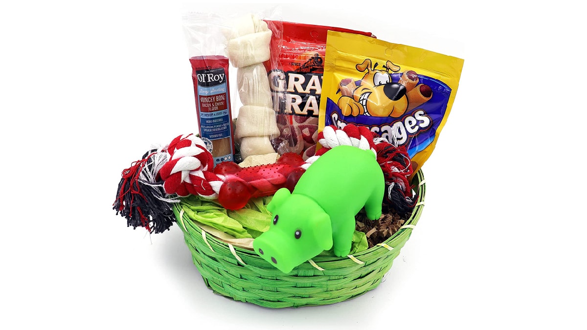 a basket filled with toys, treats, cookies, and a chew bone.