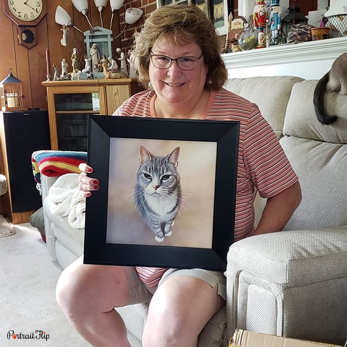 Picture of a woman holding a pet portraits including her car