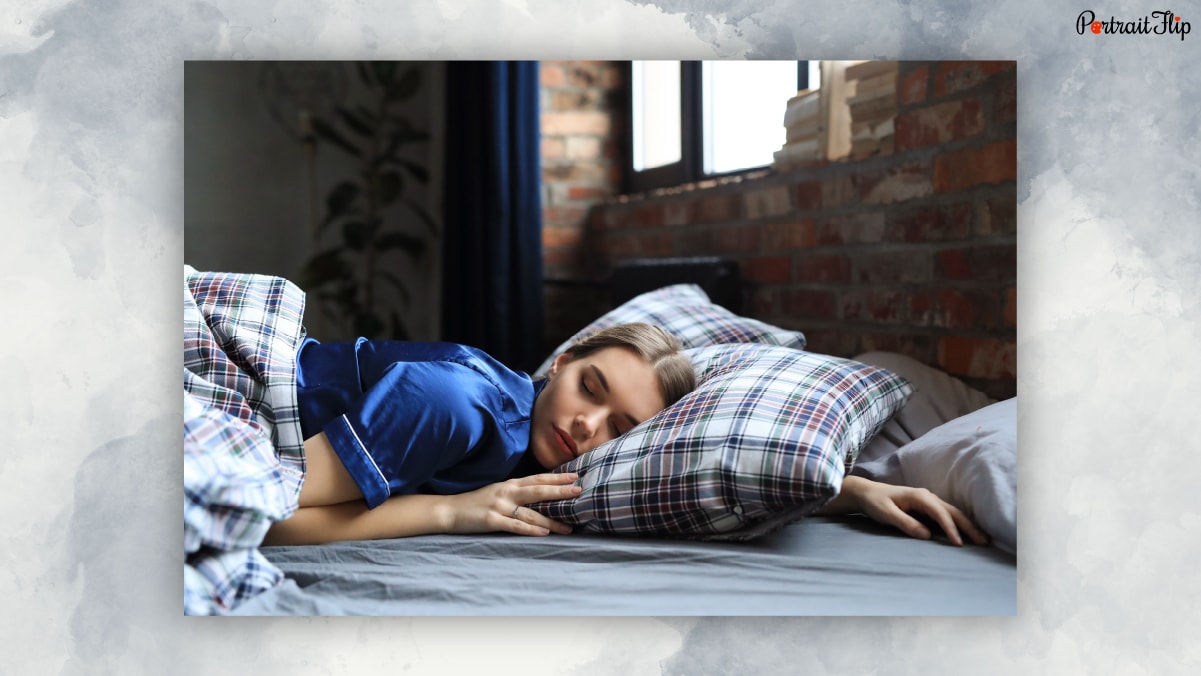 A woman sleeping on bed peacefully.