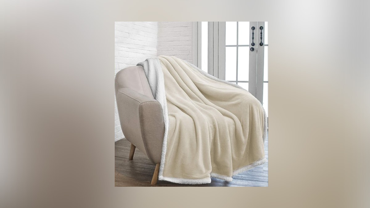 A Throw Blanket is laying on a sofa chair, a secret santa gift