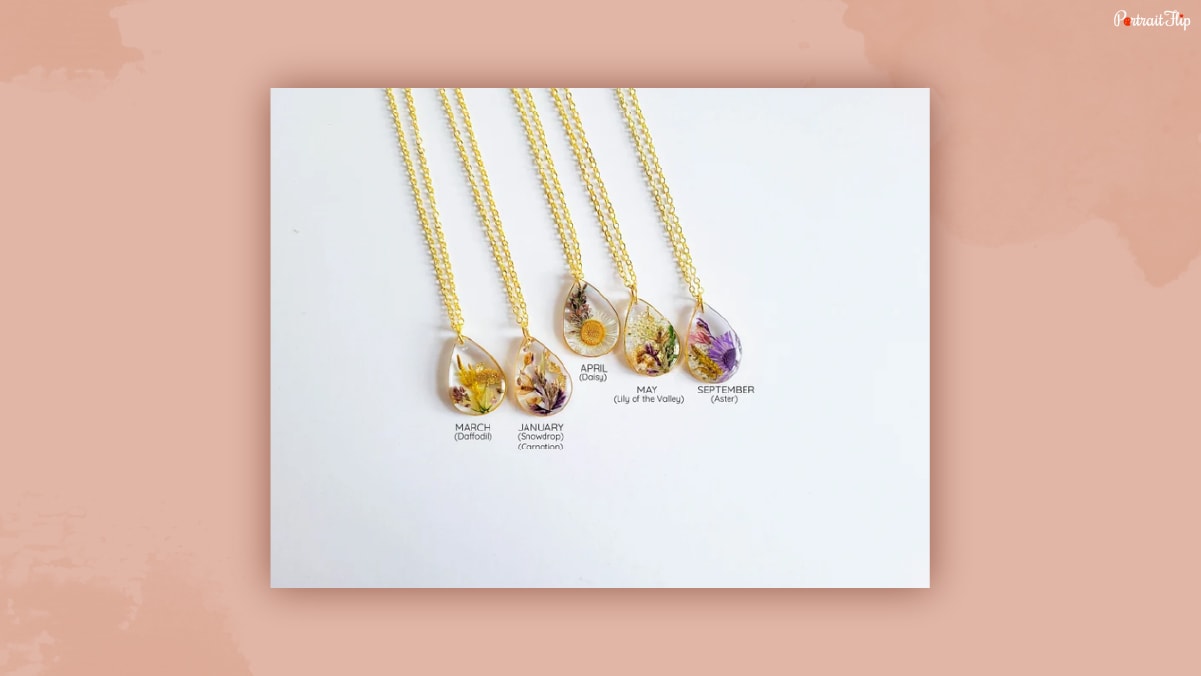 Different types of Birth Month Flower Necklace on a plain white background that could be one of the thank-you gifts for women.