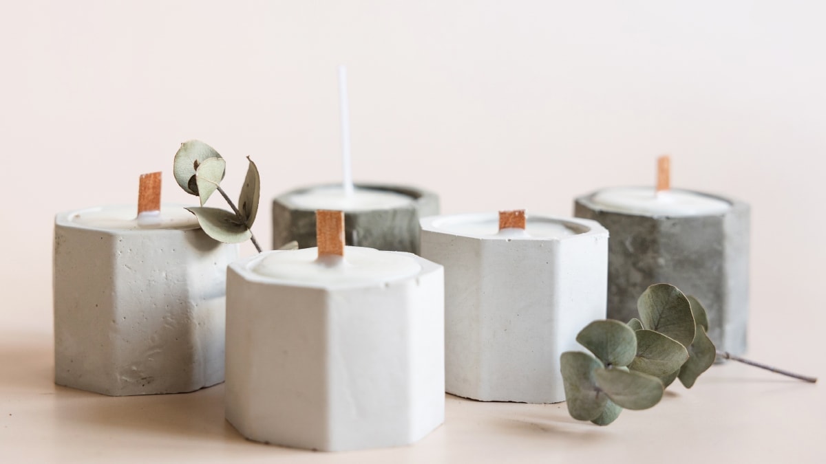 Custom handmade candles stored in pastel color containers 