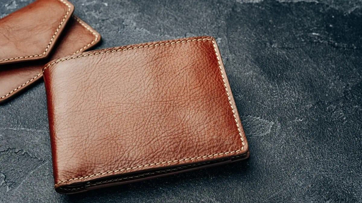 Brown color leather wallet display on a black background
