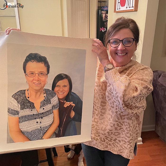 Picture of a woman holding a birthday portraits which include her with a woman behind her back