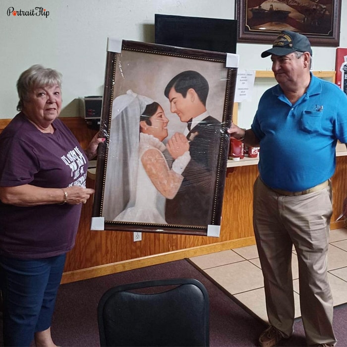 Picture of an old couple holding couple portraits that feature their wedding day as bride and groom