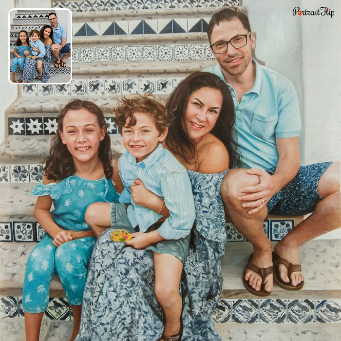 Picture of a man sitting on stairs along with a woman who has a boy in her lap and a girl beside her