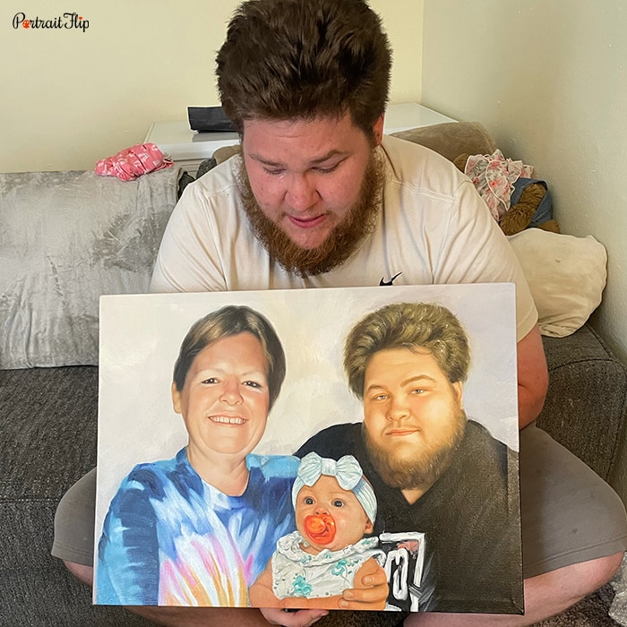 Picture of a man who is looking down at merged portraits that show him with a woman and a child in between