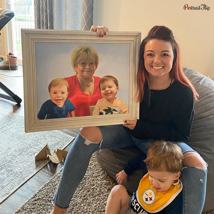 Picture of a woman holding merged portraits that show an old woman with two baby boys beside her