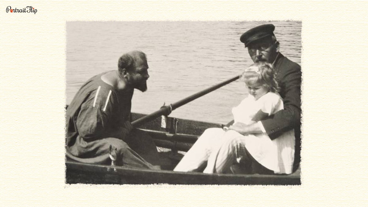 Gustav Klimt sitting in a boat with another man and a little girl. 