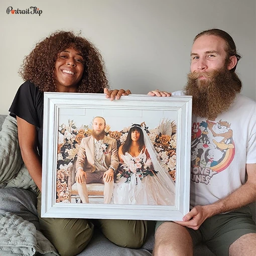Picture of a couple holding their wedding portrait