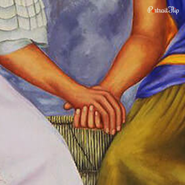 Holding hands of The Two Fridas