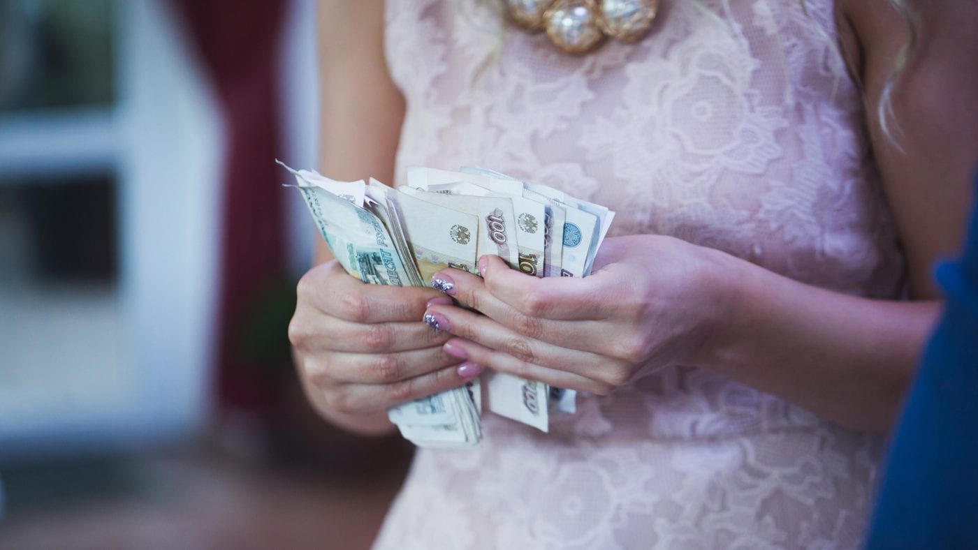 a bride keeping a count of cash