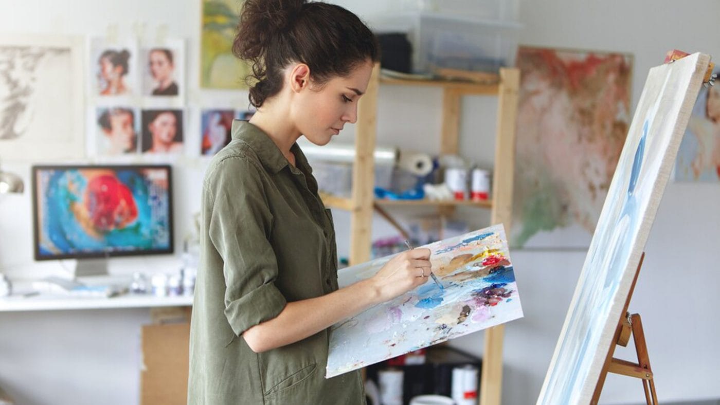 a live wedding painter with a canvas in his hands