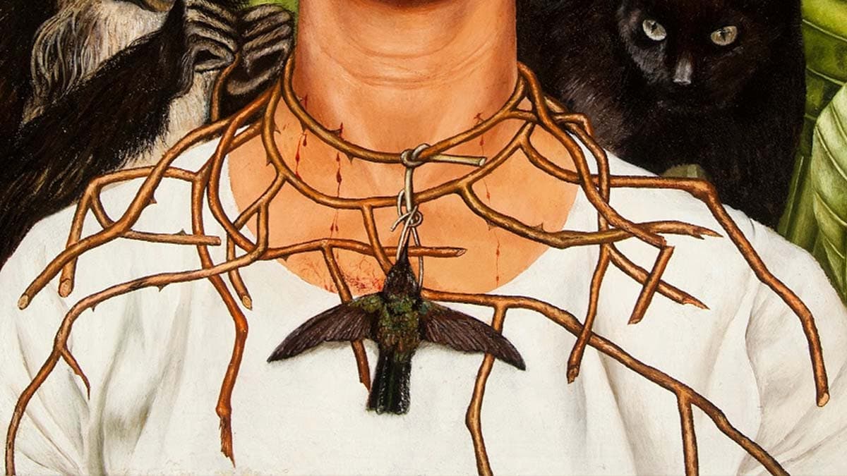 Focus on the thorn necklace and hummingbird