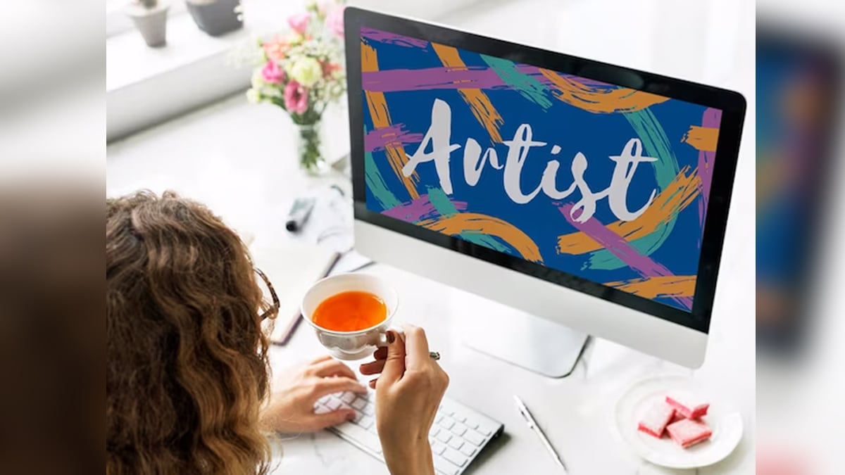A woman sitting front of a PC screen that says Artist. 