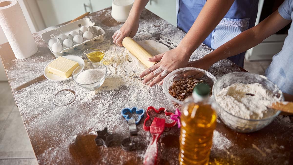 an upper view of men rolling dough