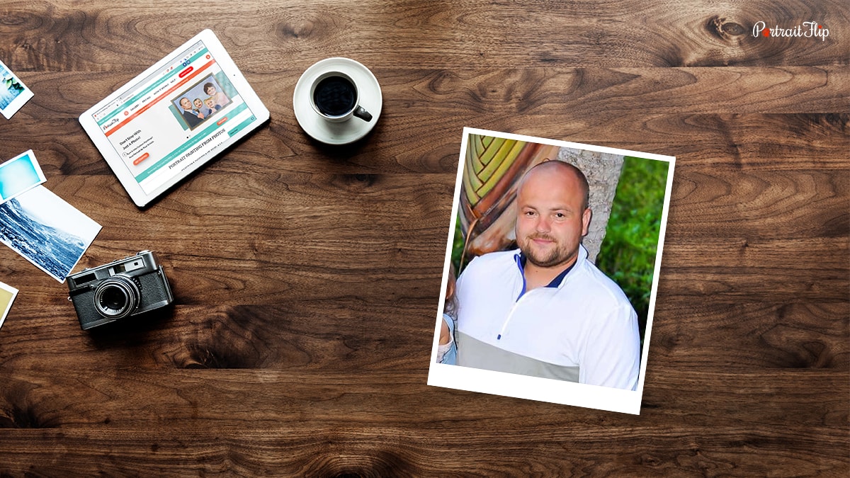 Photograph of a man placed on a wooden table