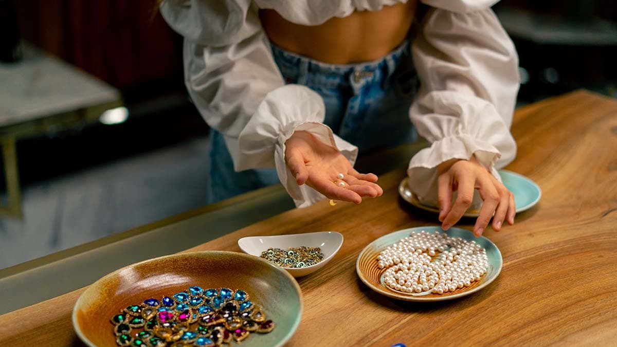 a girl picking beads from a plate