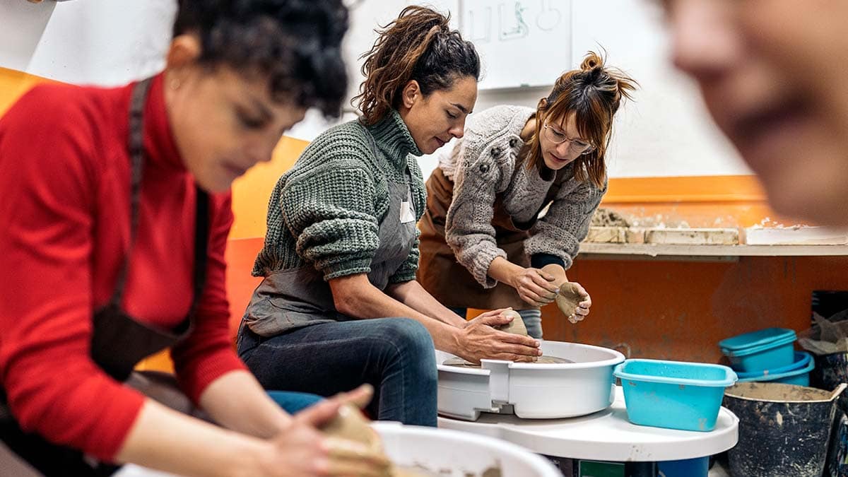 a group of girls in the pottery glass