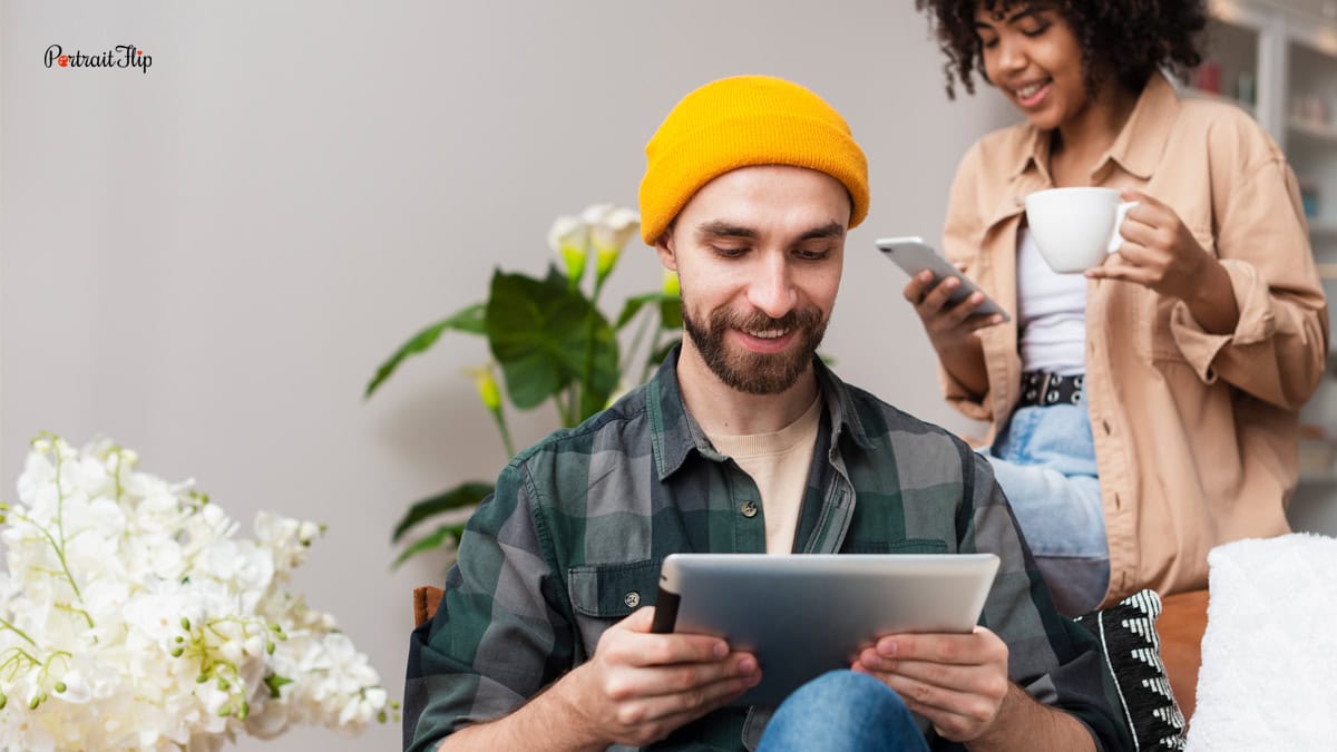 a man and a women looking at their screens