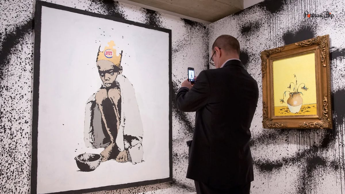 Man clicking picture on phone of a painting