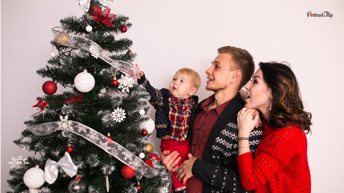 a family next to a christmas tree