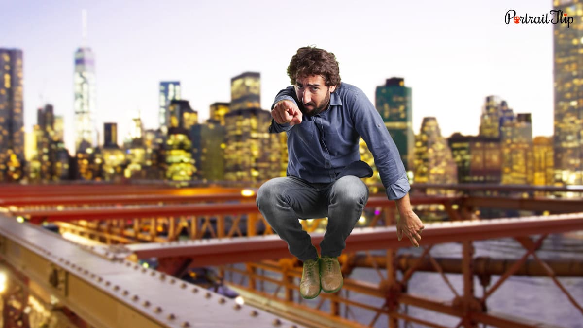 a man posing with an urban city as background