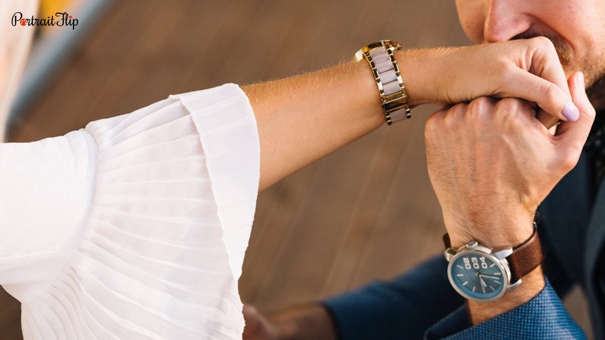A man kissing a woman's hand