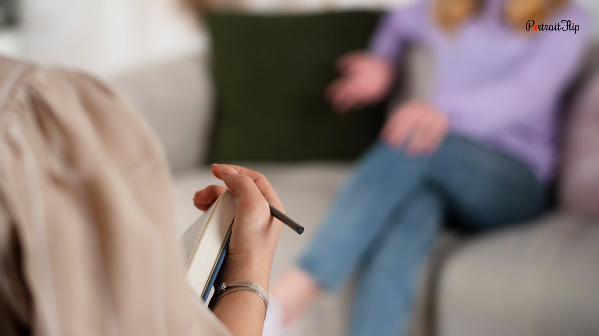 a blurred image of a girl talking to someone