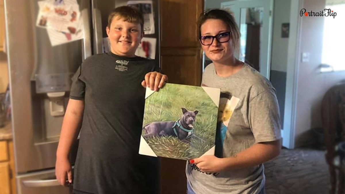 two people holding a pet portrait