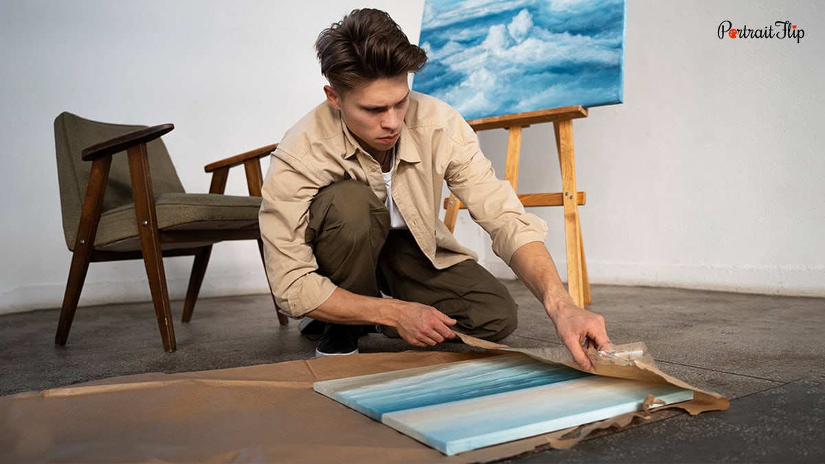 A man wrapping the painting