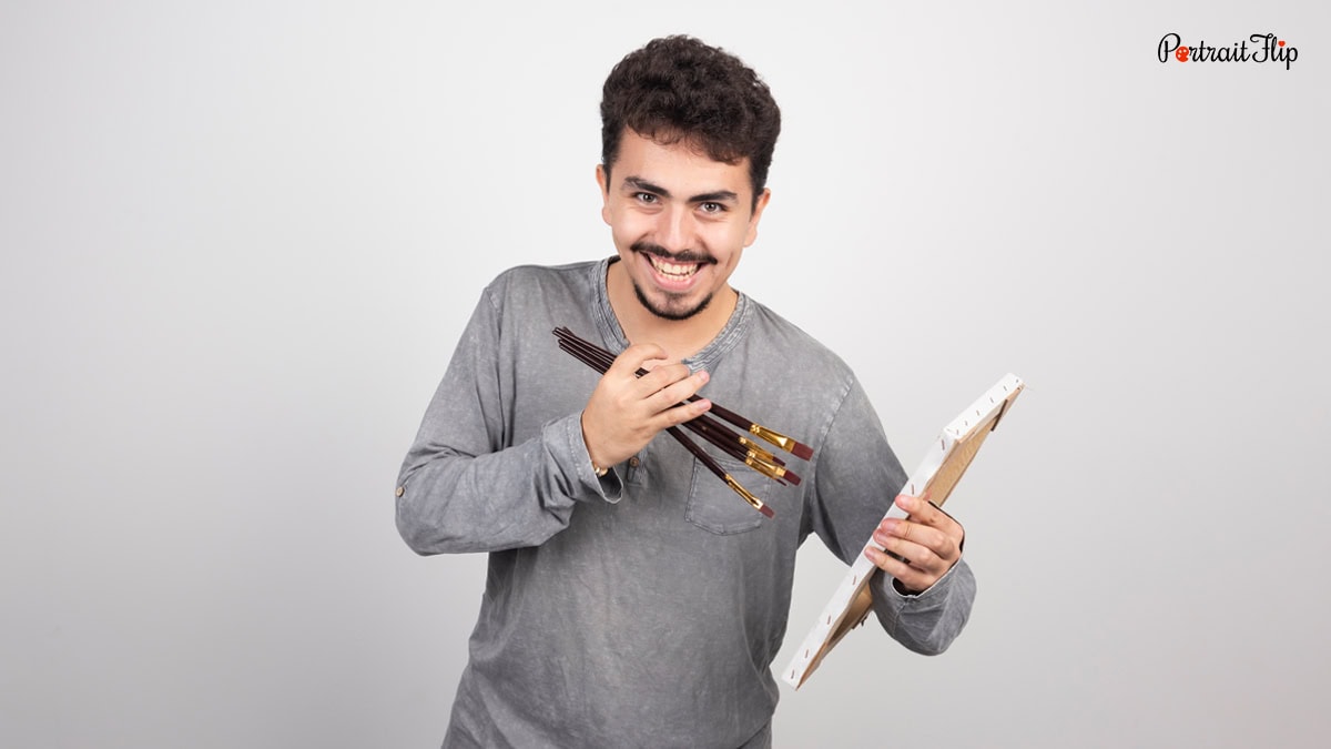 Man with canvas and paint brush in hand