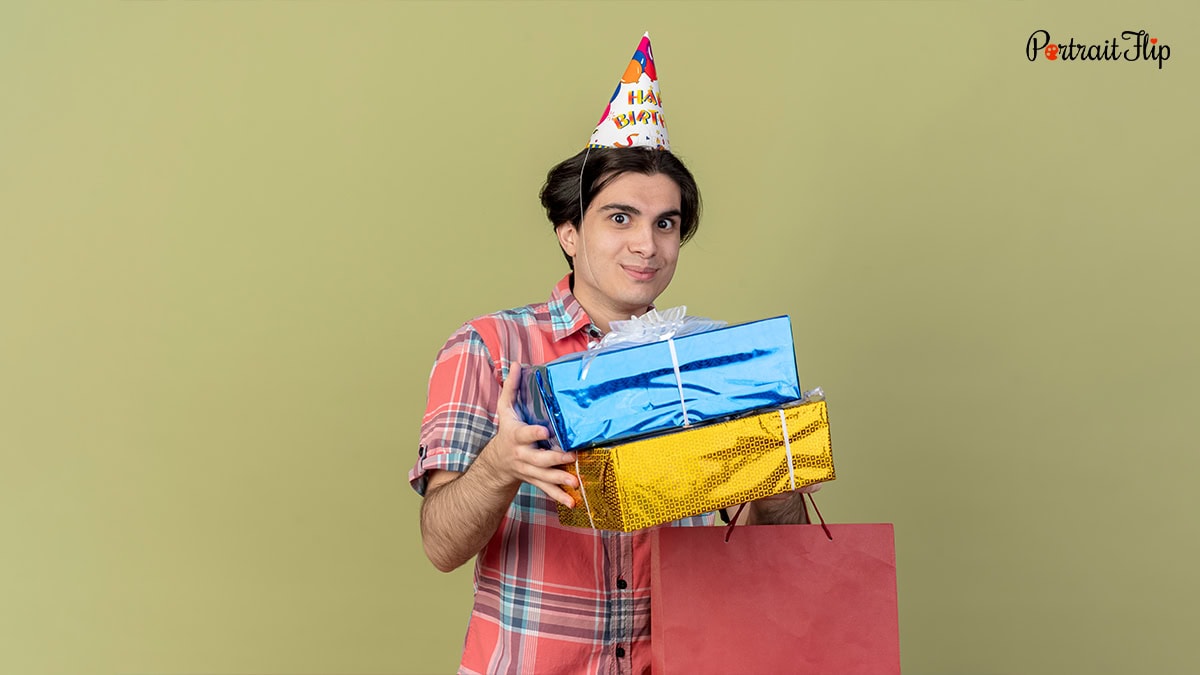 A boy with stack of gifts in his hand