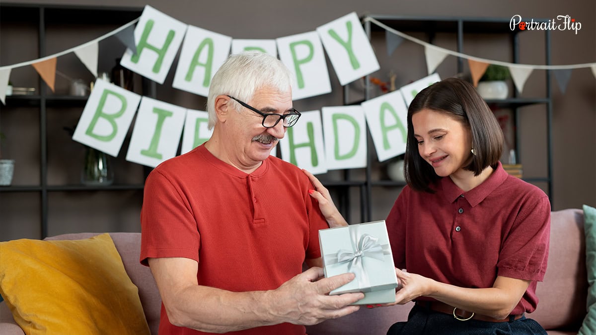 A woman handing out gift to an old man