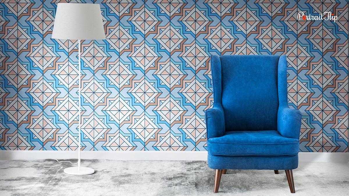 A blue sofa infront of a wallpaper design