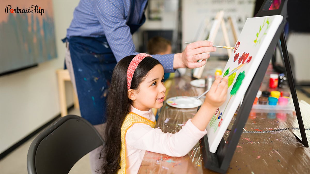 Girl coloring on canvas with pastel colors