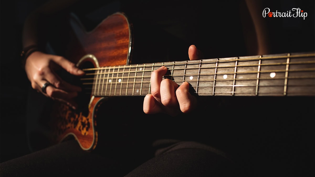 Hands playing guitar