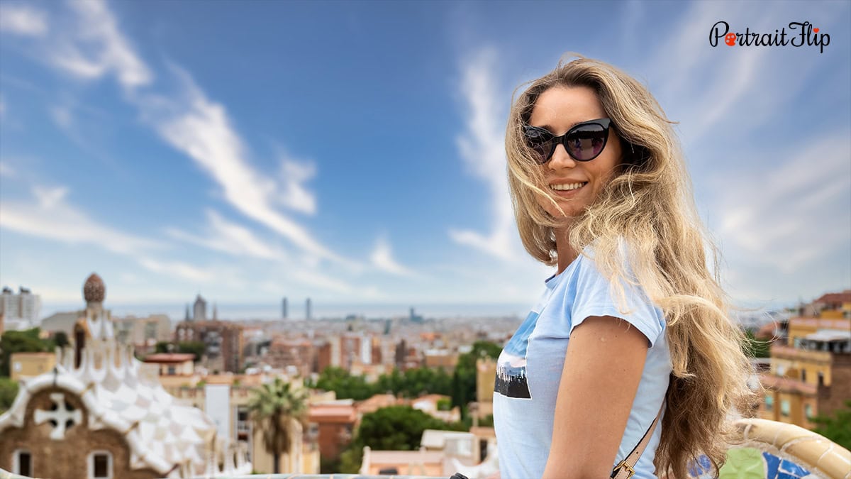 A woman posing with a scenery behind her