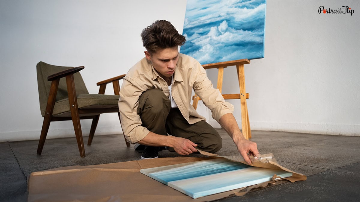 A man wrapping a handmade painting