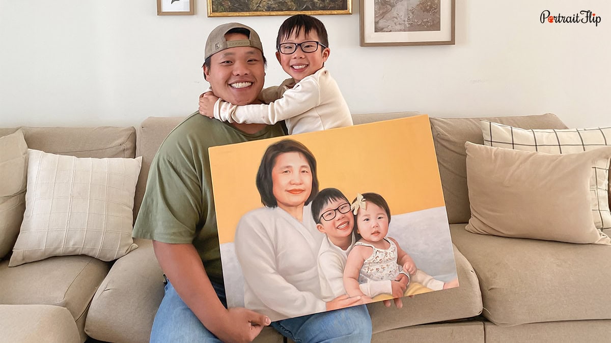 A man and a child holding a handmade painting