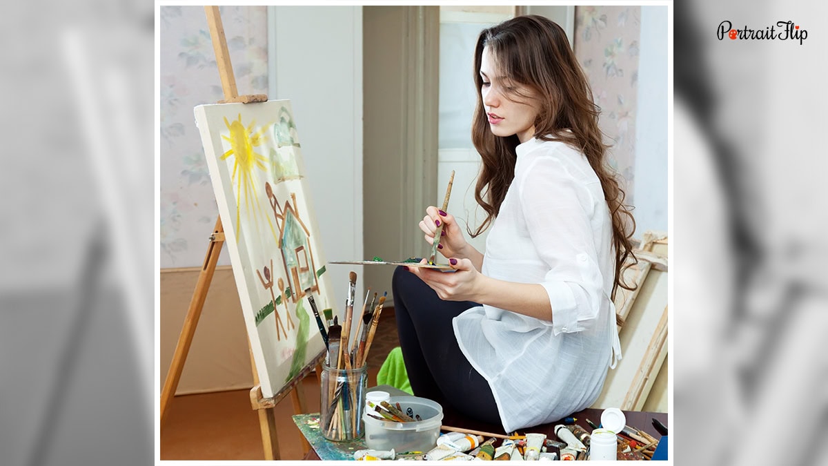 A woman painting art on a canvas