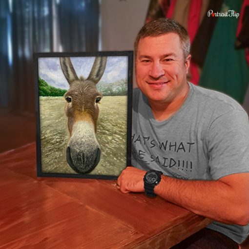 Man with a framed custom impasto donkey portrait painting