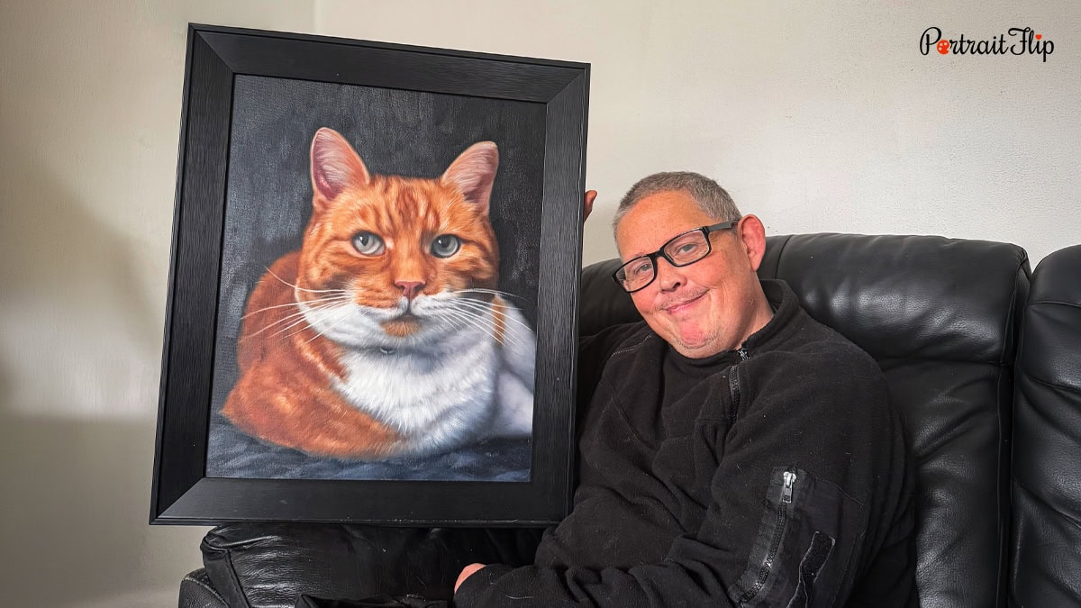 A man holding a cat portrait