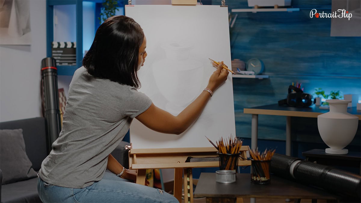 a woman painting on a canvas